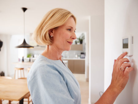 lady adjusting temperature control